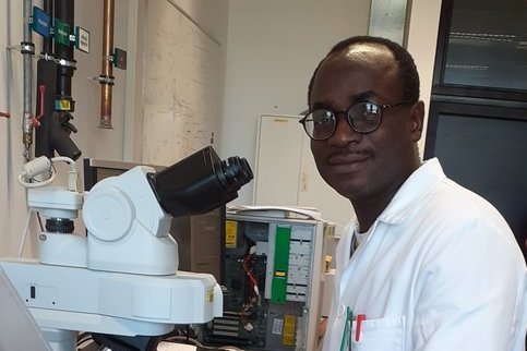 Dr. Ayodele Soge examining the morphology of the photoanode of a dye-sensitized solar  cell with an optical microscope