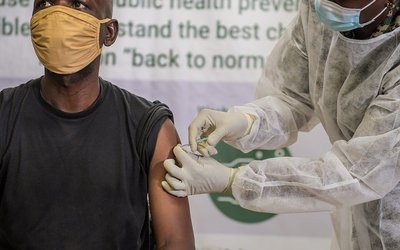 A Ugandan soldier serving under the African Union Mission in Somalia (AMISOM) takes the COVID-19 jab at the launch of the COVID-19 vaccination campaign in Mogadishu, Somalia on 17 May 2021. 